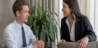 Two professionals calmly discussing an issue in a relaxed, modern office.