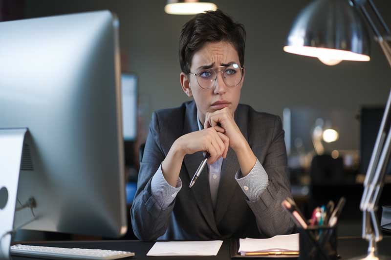 Individual sitting at a desk, reflecting on a challenging conversation.