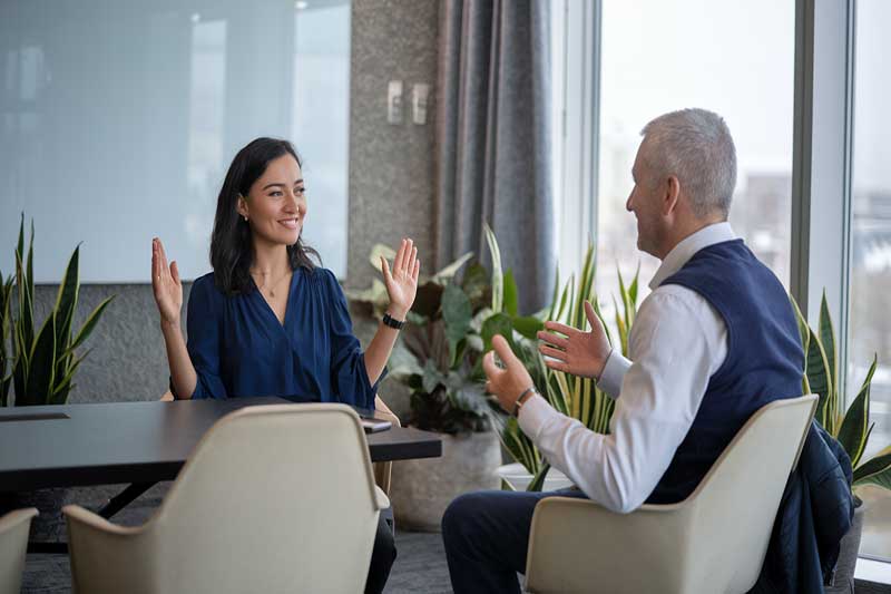 Two professionals having a positive discussion in a modern meeting room.